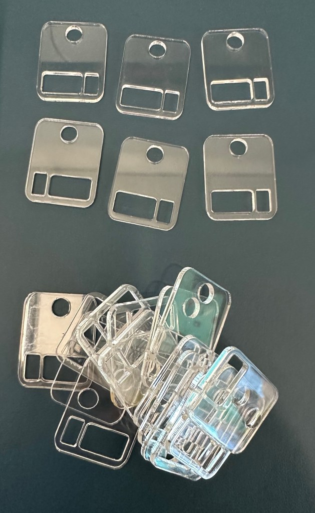 Clear acrylic floss drops. A clear square with holes to hold embroidery thread. 
